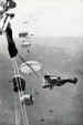 A stick of parachutists jump from a Dakota over Ringway
