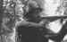 A soldier takes aim with his Sten gun outside Divisional HQ